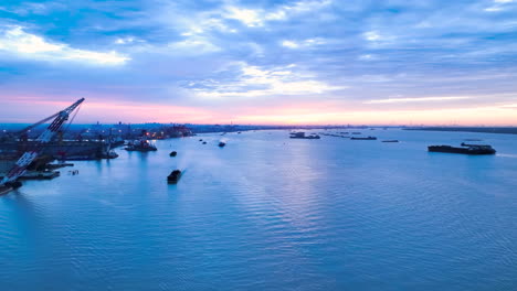 sunrise view international trade, maritime transportation hubs. container ship import export business commercial port in deep sea load and unloading cargo by crane for distributing goods