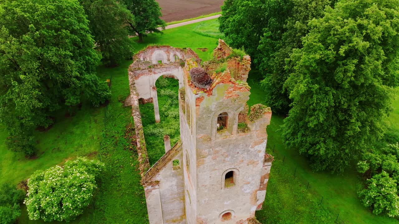 Aerial footage reveals Salgale Lutheran Church ruins surrounded by trees, fields
