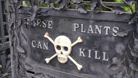 this plants can kill letters with skull crossbones poison sign, alnwick garden, england uk