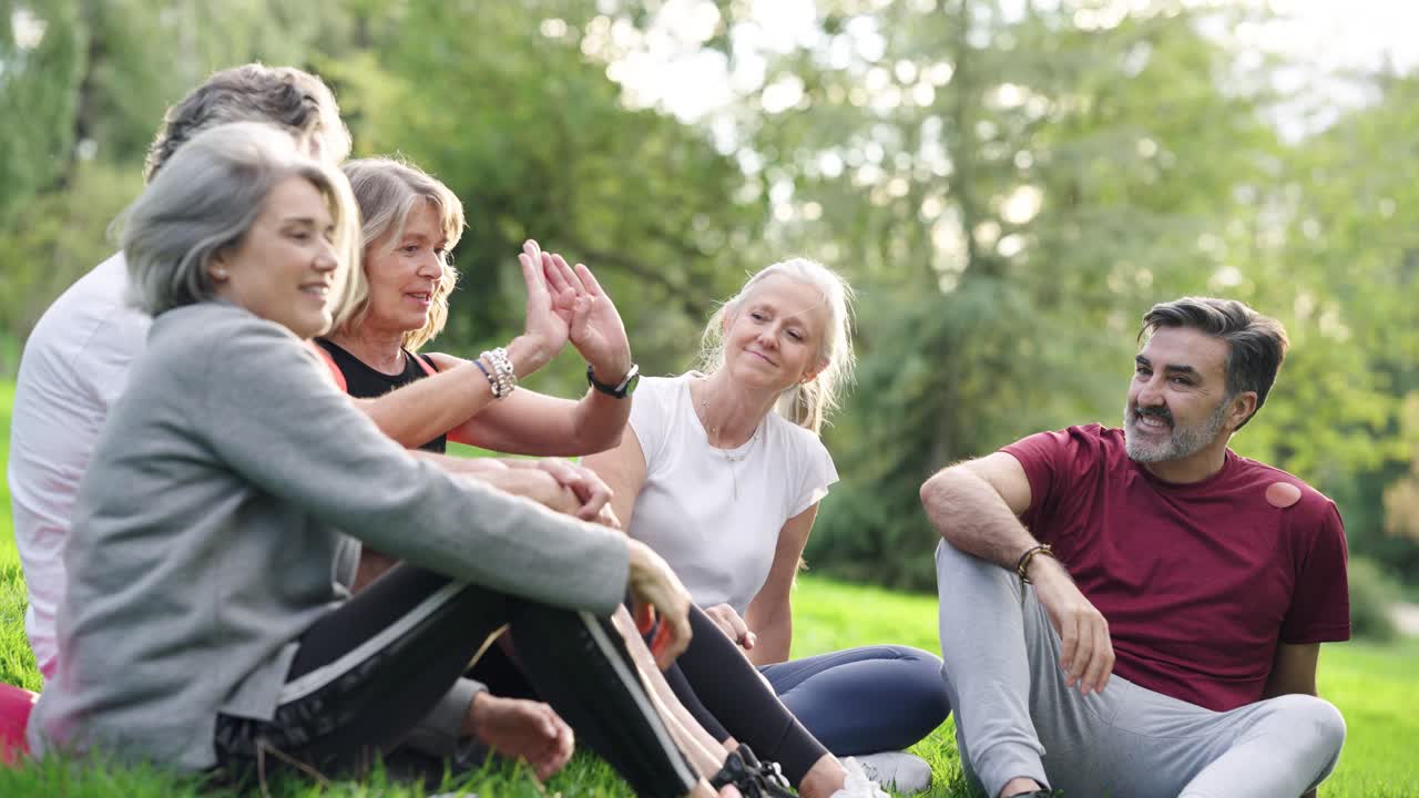 Group of seniors giving high fives in a park