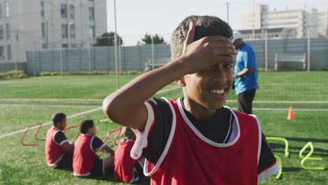 african american soccer kid exercising in a sunny day