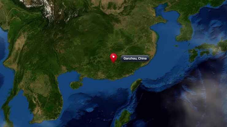 Satellite view zooms from outer space into East Asia, placing a pin on Ganzhou, China. Includes NASA public domain imagery.
