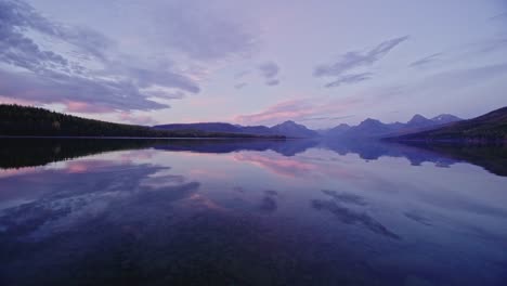 autumn scene looking across lake at colorful sunset at lake mcdonald in montana