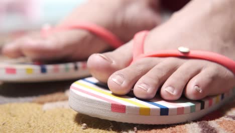 Close-up of Pink Flip-Flops on Feet