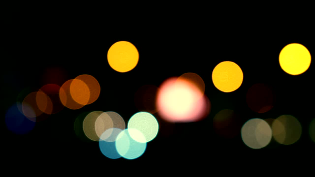 Defocused lights Los Angeles street abstract . City blur background. Moving bokeh circles of night traffic.