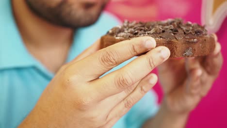 man eating a chocolate cake