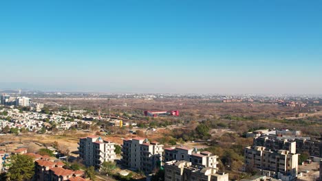 Aerial-drone-shot-of-Islmabad,-sringar-highway-with-metor-station-on-a-sunny-day