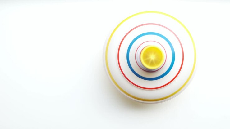 Child toy on white background, untwisted by hand of whirligig.