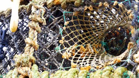 stacked empty fishing industry lobster net baskets closeup dolly left looking up