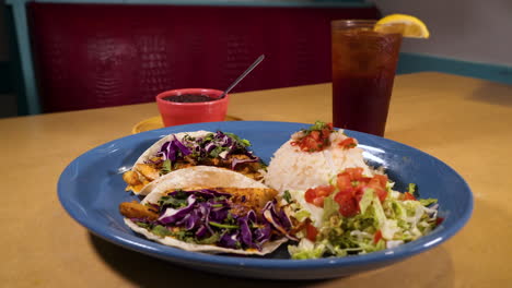 dinner plate of fresh fish tacos with white rice, black beans and guacamole, slider hd