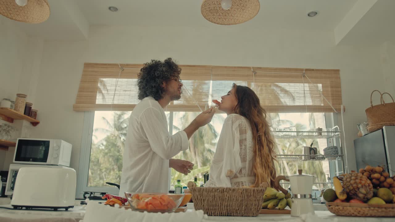 Couple enjoying a meal in a tropical kitchen