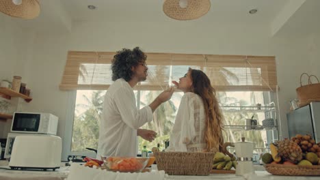 couple enjoying a meal in a tropical kitchen