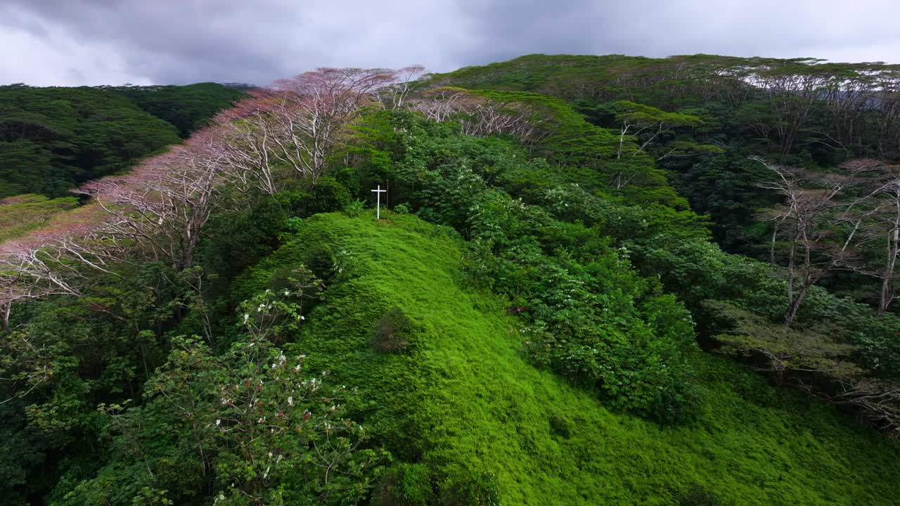 Papeno'o church White cross Jesus Christ Catholic Christian religion Tiarei Papeete Teahupoo Tahiti French Polynesia aerial drone dormant volcano mountainside lush dense jungle forest backwards