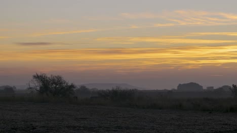 sun rising over horizon in mountains