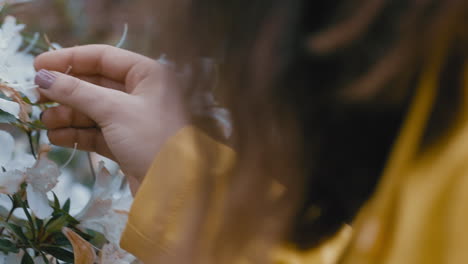 Mujer-De-Cerca-Disfrutando-De-La-Naturaleza-Tocando-Hermosas-Flores-De-Primavera-Mirando-La-Belleza-Natural-En-El-Parque-Del-Jardín