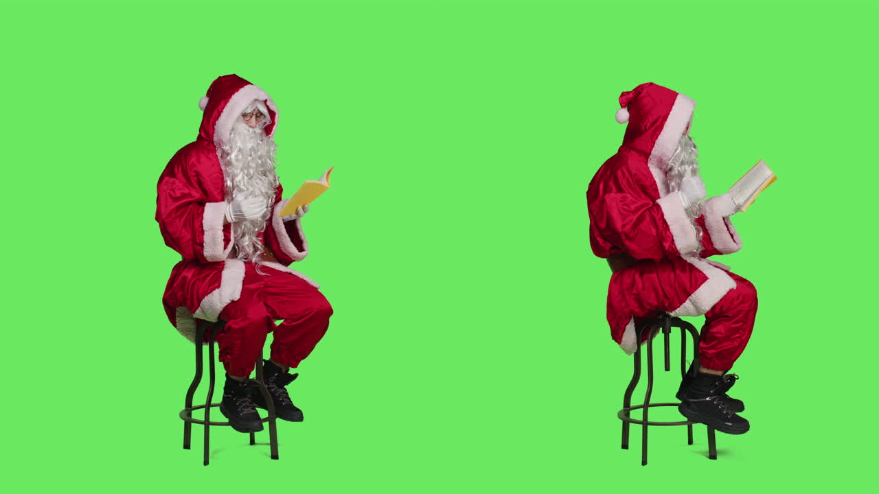 Santa Claus reading a book on a green screen