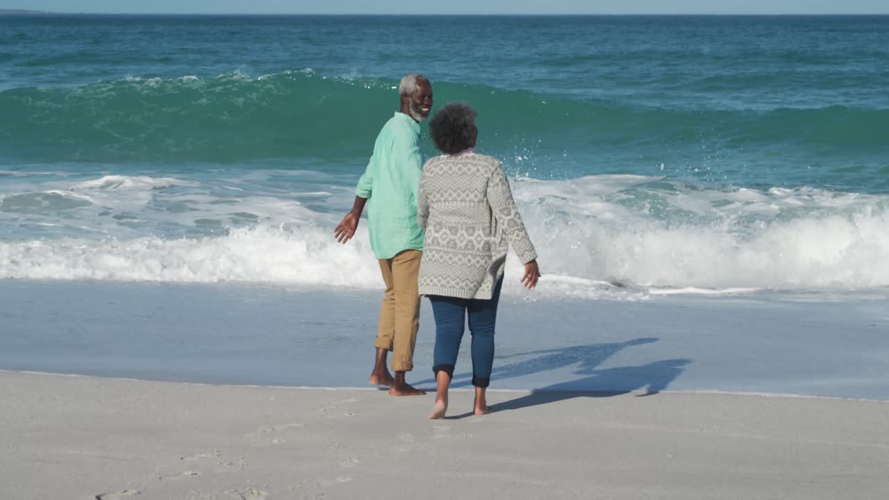 Senior couple walking through the beach