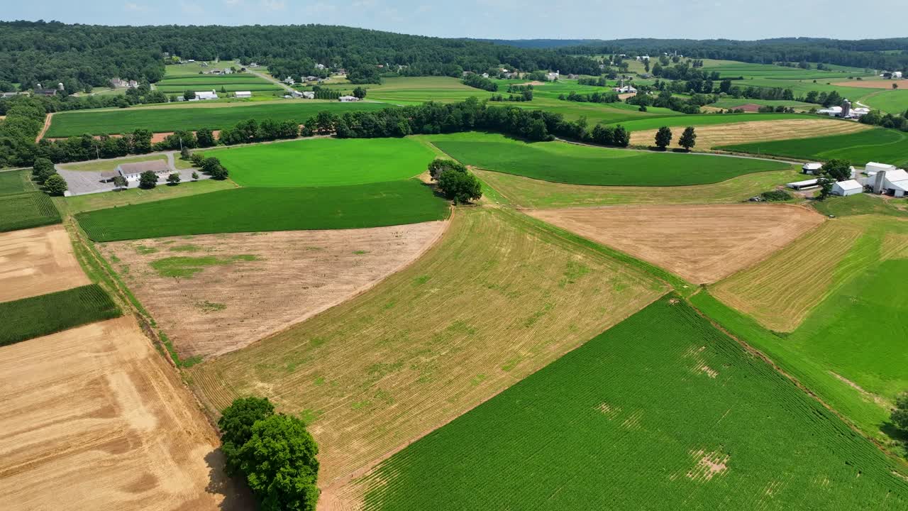 An aerial view over the lush green farmland in southern Lancaster County, Pennsylvania on a sunny summer day