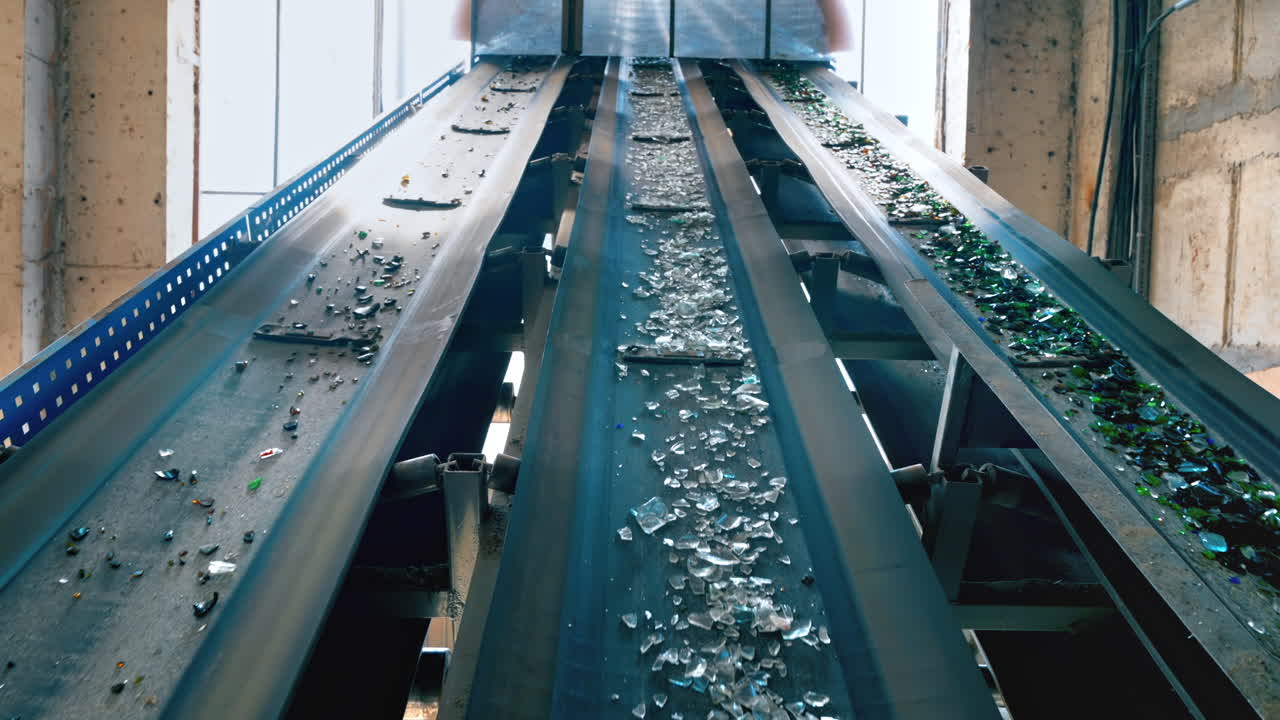 Process of sorting glass garbage on a conveyor belt at waste sorting plant