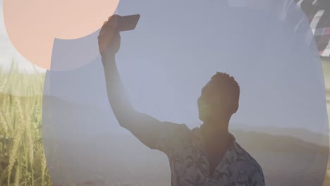 animation of frame over happy african american man taking selfie