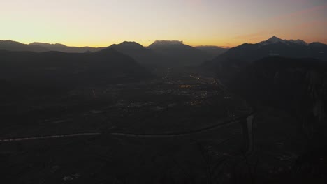 Superb-city-top-view-at-sunset-of-Trentino-Italy,-mountains-in-the-background