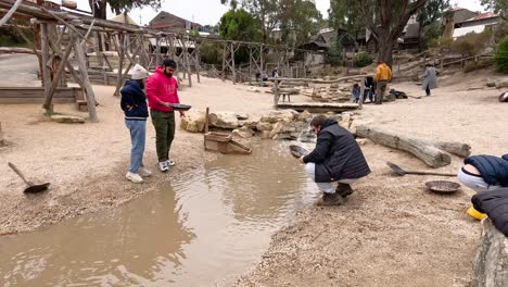 people panning for gold in a historical setting