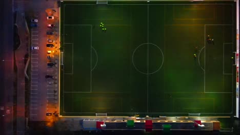 straight down shot of a football field in the dark with lights sliding right in santa ponsa, mallorca, spain