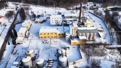 Aerial-view-of-an-industrial-building-in-winter,-Silute,-Lithuania,-Germany