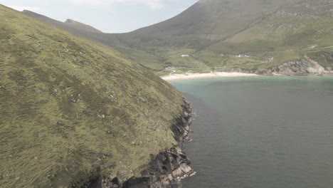 beautiful blue waters and white sand in a cove in achill island - aerial shot