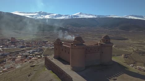 aerial view of the castle of la calahorra with sierra nevada behind in granada, spain