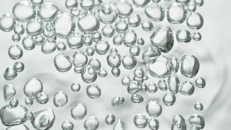 upwards drifting transparent bubbles in low angle on white background