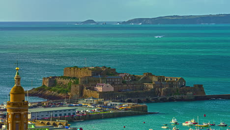 Coastal-view-of-Castle-Cornet-in-Guernsey,-channel-islands,-with-passing-boat,-timelapse,-sunny-day