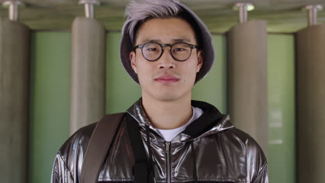 portrait of young attractive asian man looking serious student wearing jacket glasses