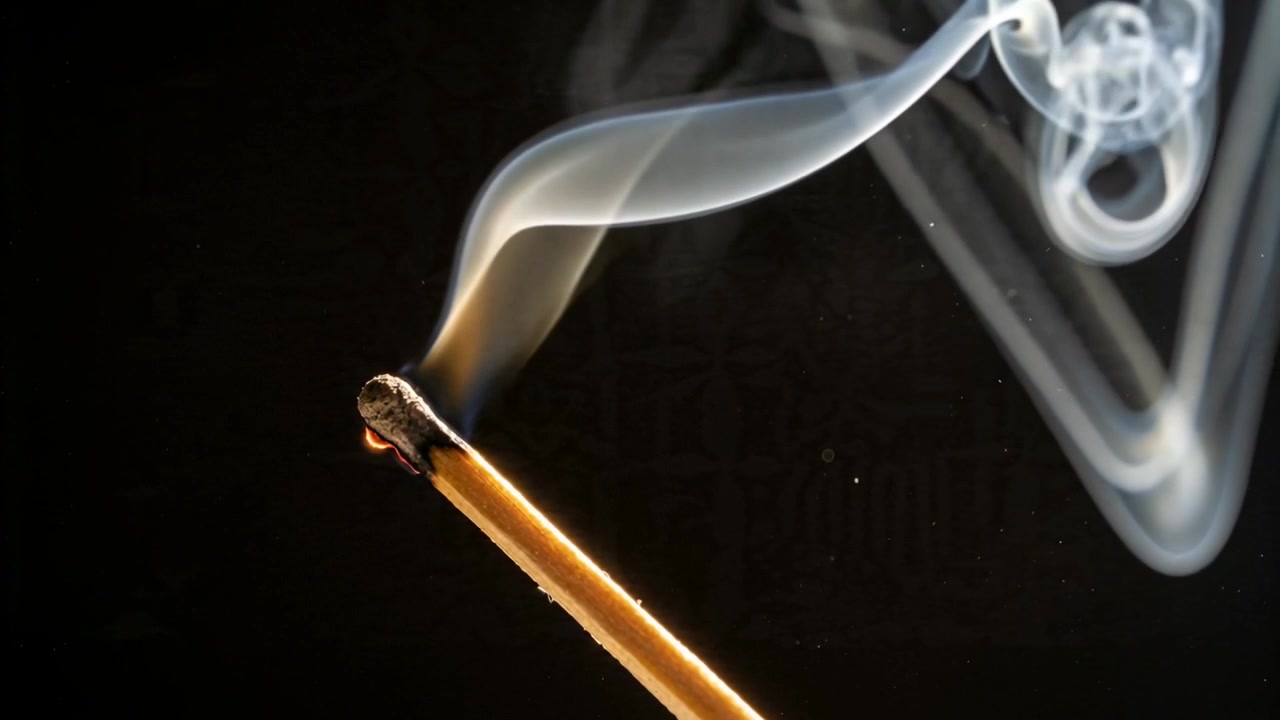 Fumo che si arriccia, bastoncino d'incenso acceso che forma spirali in studio, allungando nastri mentre la brace si consuma.