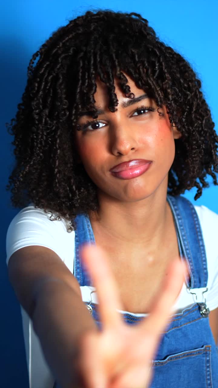 Portrait of Smiling Woman with Peace Sign