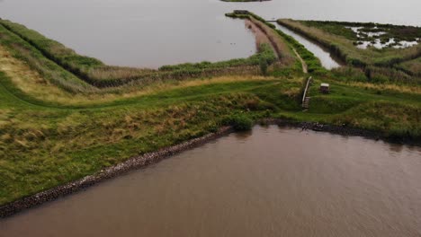 Aerial-Looking-Down-At-Grass-Verge-Path-Beside-River-Noord-In-Ridderkerk