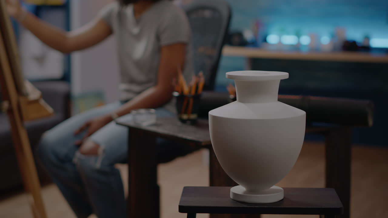 Close up of white vase on table in art studio room at home