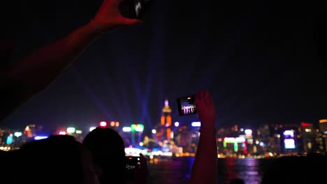 people photographing vibrant city lights at night