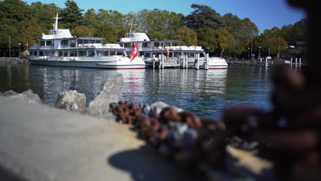 reveal from rusty chains at dock to large ship in harbor