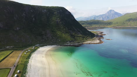 wide rotating aerial footage of vik beach and hauklandstranda norway, coastline drone shot with turquoise blue water