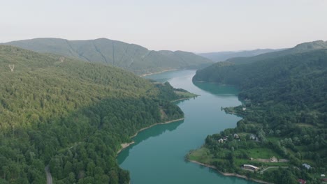 vista of mountains densely covered with trees along doftana river in prahova county, muntenia, romania