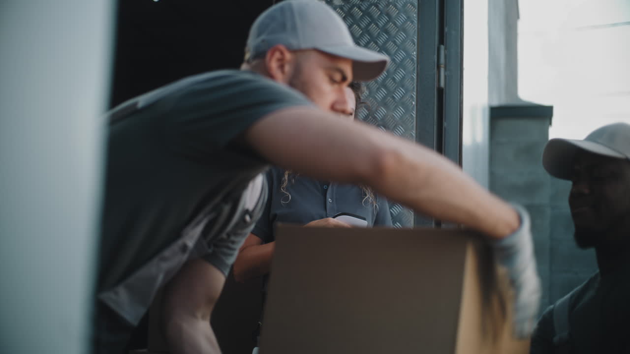 Delivery Team Manages Logistics and Packages with Digital Tablet