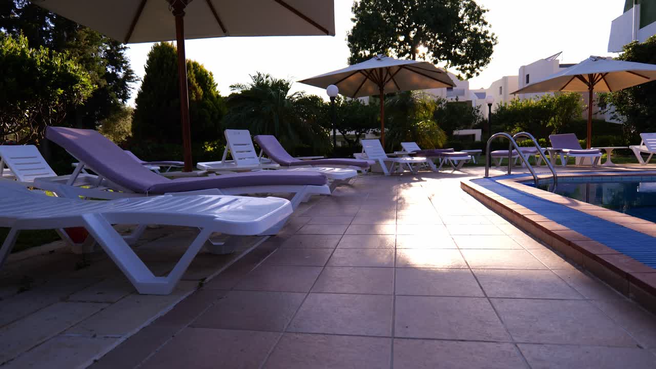Sunbed With Parasols At The Poolside Of A Private Resort In Rhodes, Greece