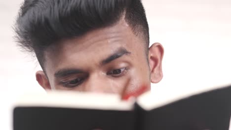 young man reading a book