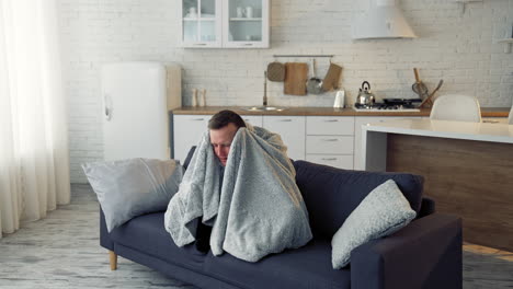 sick young man suffering from flu at home. pandemic. quarantine concept.