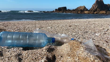 plastic bottles left on a beach, emphasizing ocean pollution and climate-related environmental issues