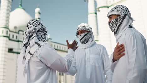 men in traditional middle eastern clothing near mosque