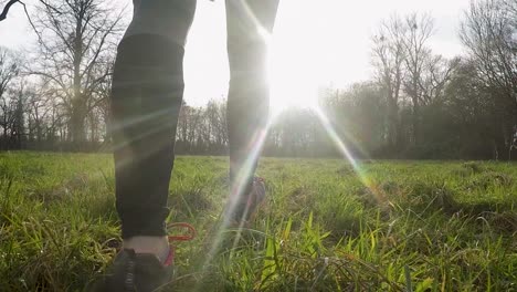 woman in sportswear walking through grass