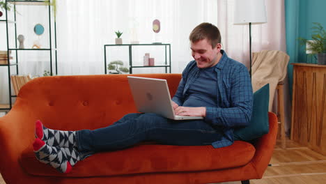 surprised amazed shocked man using laptop receive good news victory celebrate lottery jackpot win