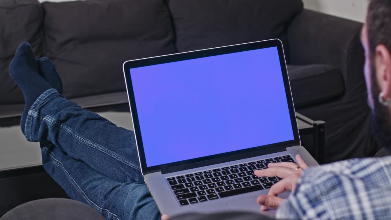 Man Working at Home on Laptop Computer